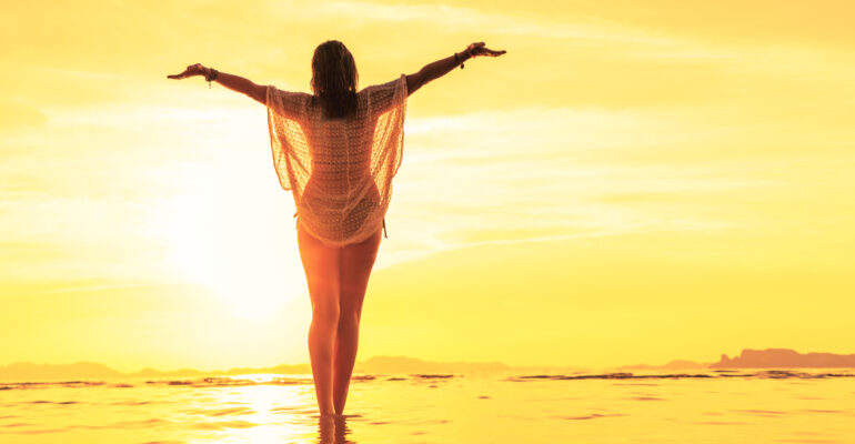 Woman,On,Holidays,At,The,Tropical,Beach,At,Sunset